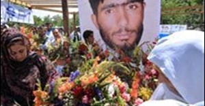 Afghan journalists place flowers in front of a photograph of the late Afghan journalist Abdul Samad Rohani during a silent mourning' gathering in Kabul on June 12, 2008. The initial findings of a government investigation indicate the Taliban shot the young BBC reporter who was found dead. AFP Photo/Shah Marai