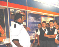 Learners listen to a representative from Waste Giant as he explains how a recycling process can be set up at their school.