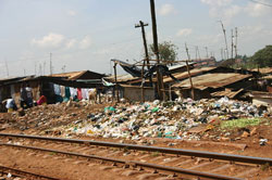 Trash by the railroad tracks. Kibera. (Image: Arria Belli, via Wikimedia Commons)