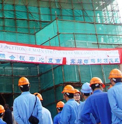 Shanghai Construction Company workers outside Malawi's new five-star hotel. (Image: Claire Ngozo/IPS)