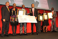 Tourism minister Marthinus van Schalkwyk, SA Tourism CEO Thandiwe January-Mclean with all overall 2011 Eteya winner Kagiso Legobe, while other laureates look on