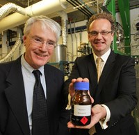 (L-R) Professors Brian Haynes and Thomas Maschmeyer holding a bottle of biocrude oil.
