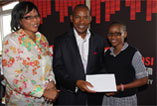 Beneficiary Anele Zondi from Pietermaritzburg poses with MD of Gagasi FM Mr Chris Meyiwa and her mother as she receives the R10 000 school fees, R700 stationery voucher and a R500 Uniform voucher courtesy of Gagasi FM