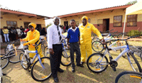MTN Group's Rich Mkhondo (right) hands over bicycles to Dithabaneng Primary School learner Zwelakhe Shongwe (middle) and principal William Madidimallo.