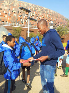 Happy Jele giving his autograph to his young fan