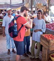Maunder talks to traders at the spice market in Old Town, Mombasa