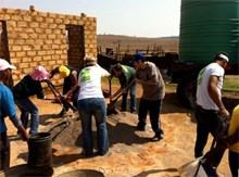 BMi Research staff enjoying the day in the sun while making bricks for Ubuhle Day Care Centre