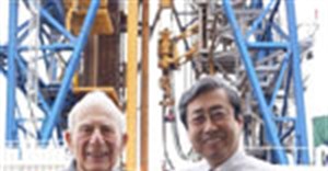 JAMSTEC president Asahiko Taira with Walter Munk on the deck of D/V Chikyu in front of the ship's drilling derrick. Credit: JAMSTEC