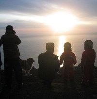 A group of Icelanders giddy with excitement as they watch a solar eclipse; the island nation’s small population means that many Icelanders are related, but probably don’t know it.