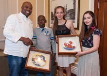 Masterchef SA judge Benny Maskwikameng (left) and Junior Masterchef Austalia winner Isabella Bliss and her twin sister Sofia (right, who also reached the top four in the hit show) receive a special award, created by the Lalela Project, from Grade 7 learner Saki Sifuba at the official launch in Cape Town of the Good Food & Wine Show. It was also announced at the launch that Food Hospitality World will be coming to Cape Town next year which will make the Mother City the culinary capital of Africa.<p>Image credit: Jurie Senekal