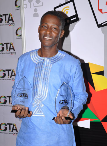 Donald Gwira holding the two awards
