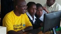 MTN's Capital Projects Manager Nicholas Beijuka illustrates to students of Bweranyangi about e-learning.