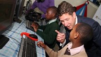 Christian Turner, British High Commissioner with a pupil of Kilimani Primary School during the launch of a digital hub. Image credit: Diana Ngila via