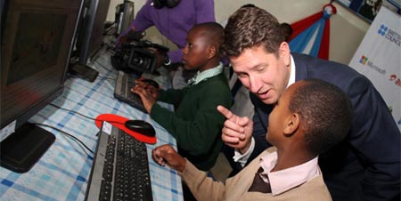 Christian Turner, British High Commissioner with a pupil of Kilimani Primary School during the launch of a digital hub. Image credit: Diana Ngila via