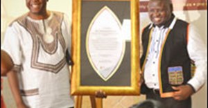 National Heritage Council’s CEO, Advocate Sonwabile Mancotywa hands over the award to the SATMA founder, Dumisani Goba