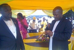 MTN general manager Mobile Money, Phrase Lubega and a Buganda official at the commissioning of the Mobile Money fundraising platform for Buganda Kingdom in Mukono.