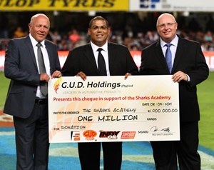Red Shuttleworth, CEO (left) and Ian Law (right), Sales & Marketing Director of G.U.D. Holdings presents the cheque to Etienne Fynn, Managing Director of the Sharks Academy (centre)