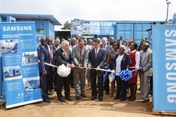 Hans Ludolph, Albert Chanee and Minkyu Lee officially open the Digital Village as government officials and community members look on.