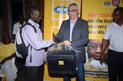 MTN CEO Mazen Mroue hands over a gift to one of the participants in the SME Trainiing in Eastern Uganda.