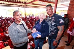From left to right: Zodwa Dibe, Boitshepo Catholic School; Sharon Smith, Bavarian Mototcycles and DJ Fresh, 5FM handing over one of the Dignity Dreams products at Boitshepo Catholic School in Hammanskra.