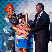 Story teller Gcina Mhlophe with Andile Mkhize from Umlazi Primary school hand over a flame of hope to the Mayor Cllr James Nxumalo