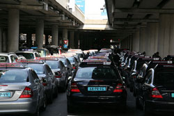 Taxicabs in Schiphol Airport. Traditional taxi drivers reckon the Uber service constitutes unfair competition. (Image: Public Domain)