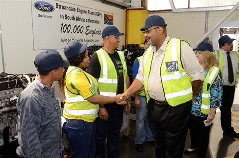 Teddy Taylor, US Consul General, meets some of the Ford Struandale Engine Plant's engine assembly team.