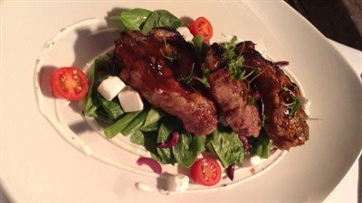 Grilled Lamb Chops served with Hummus, Feta, Olives, Baby Spinach and mint Yogurt