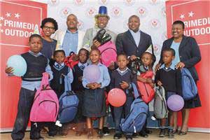 The Maluti-a-Phofung Local Municipality’s executive mayor, Vusi Tshabalala (middle), with representatives of Primedia Outdoor, the principal of the Sentebale Primary School and some of the beneficiaries