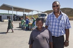 Job Mpele, Group Human Resources Director of the Rhodes Food Group with one of the farmers.