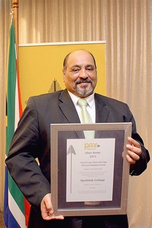 Northlink College CEO and Principal, Leon Beech, standing with the Silver Arrow PMR.africa Award
