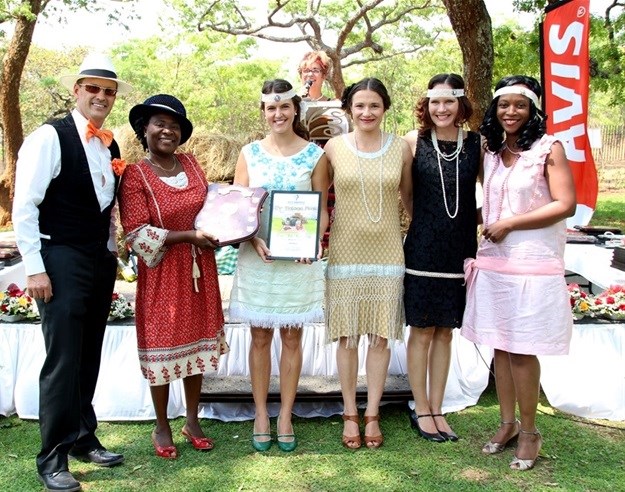 Africa Albida Tourism staff receive the Best Self Catering Award for Lokuthula Lodges from AZTA chair Ruby Tombindo