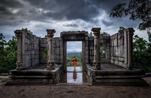 A buddhist monk at the temple ruins of Yapahuwa, Sri Lanka