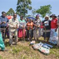 Cooperative members and Tongaat Hulett representatives prepare to plant their food gardens