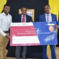 Norman Muga and Mburu Njunge pose for a photo with principal secretary Ministry of Information and Communication Dr. Victor Kyalo when they received their prize.