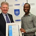 Neville Otuki (right) accepting his award last year
