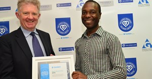 Neville Otuki (right) accepting his award last year