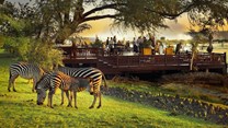 Royal Livingstone - Deck at sunset with zebras