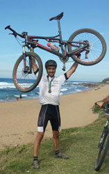 Henri Joubert, who was this the City Lodge Hotel Group’s international business development manager until the end of March, raising his bike after completing the 2015 edition of the event.