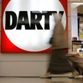 People walk past the logo of electrical goods retailer Darty shop in La Defense near Paris, France, last week. Image credit: