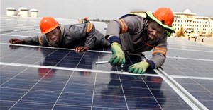 Installing solar panels on Emperors Palace rooftop