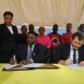 The Permanent Secretary in the Ministry of Communications, Works and Infrastructure, Prof Faustine Kamuzora (seated, left) and Tigo chief commercial officer, Shavkat Berdiev (seated, right), sign a Memorandum of Understanding in which Tigo will provide internet access to Tanzania’s secondary schools through the e-Schools Project.