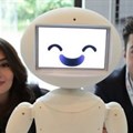 LuxAI's robot with Aida Nazariklorram, co-founder and chief medical officer, and Pouyan Ziafati, founder and CEO.