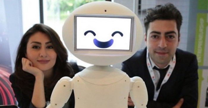 LuxAI's robot with Aida Nazariklorram, co-founder and chief medical officer, and Pouyan Ziafati, founder and CEO.