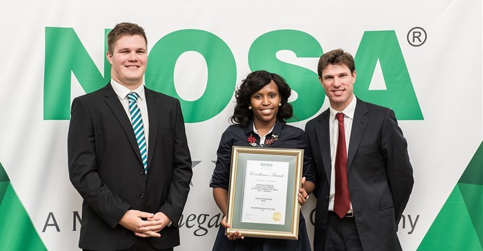 Recipient of the NOSA award in the middle Sinegugu Shangase, technical supervisor DCT, who received the SHE Rep award.