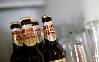 Bottles of SABMiller's flagship brew, Castle Lager, at a bar in Cape Town. Almost 120 years after first listing, its name will disappear from the JSE board this week.<p>Picture: