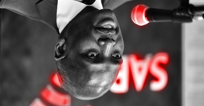 Yes, it's intentionally upside down... Hlaudi Motsoeneng, chief operating officer of the SABC, holds the corporation’s first quarterly media briefing in Johannesburg on Wednesday, 28 January 2015. Picture: SAPA stringer. ©