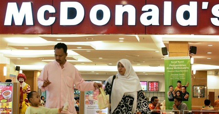 A Malaysian family leaves US fast food chain restaurant McDonald's. Picture: