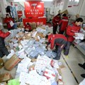 Deliverymen sort through packages of goods at a collection centre in Beijing on 9 November 2016 |