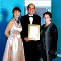 Mike Myers (centre), receives The Gold Winner Award for Tourism from Michelle Geraghty, FNB Regional Head, Gauteng South West (left) and Marietjie Esterhuizen, ROCCI President, (right).